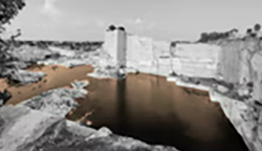 Quarry basin and isolated stone tower within the existing excavation.